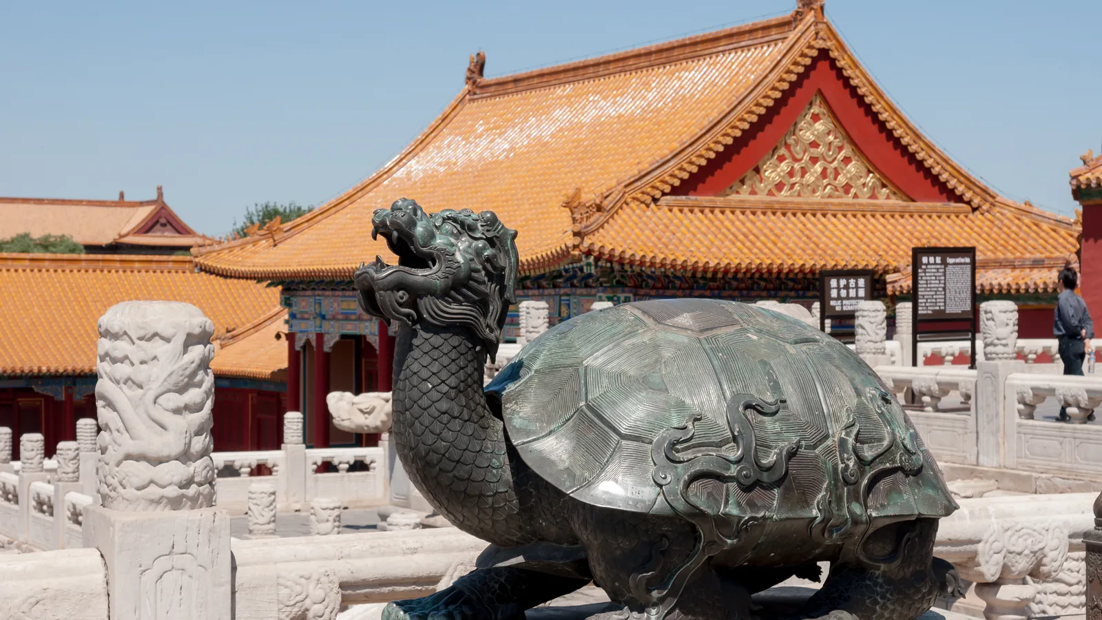 Bronze tortoise sculpture and golden roofs inside the Forbidden City