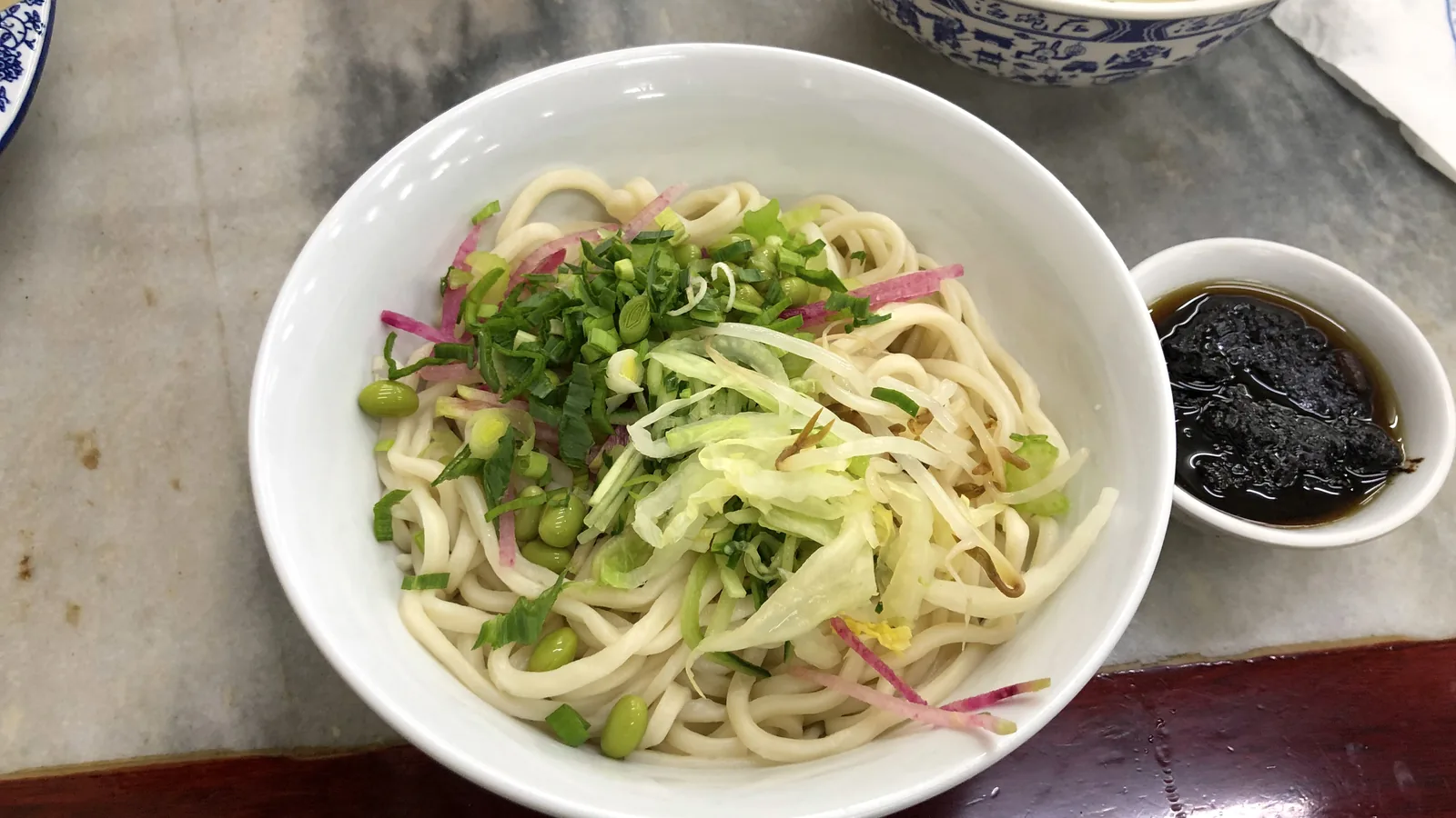 Bowl of Beijing noodles with vegetables and fermented bean sauce