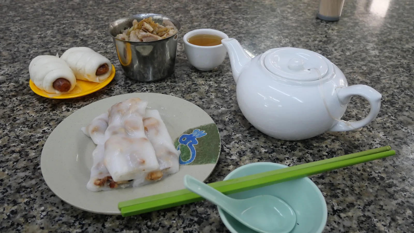 Cantonese tea with rice noodle rolls and steamed buns on a Guangzhou table